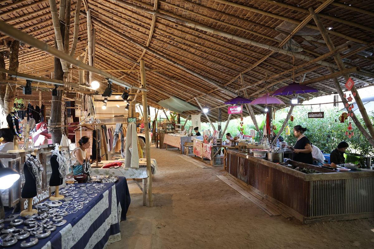 The market hall: stalls of silver, clothes and crafts under the long bamboo roof